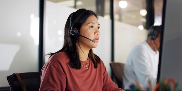 photo of a call centre and a woman answering questions