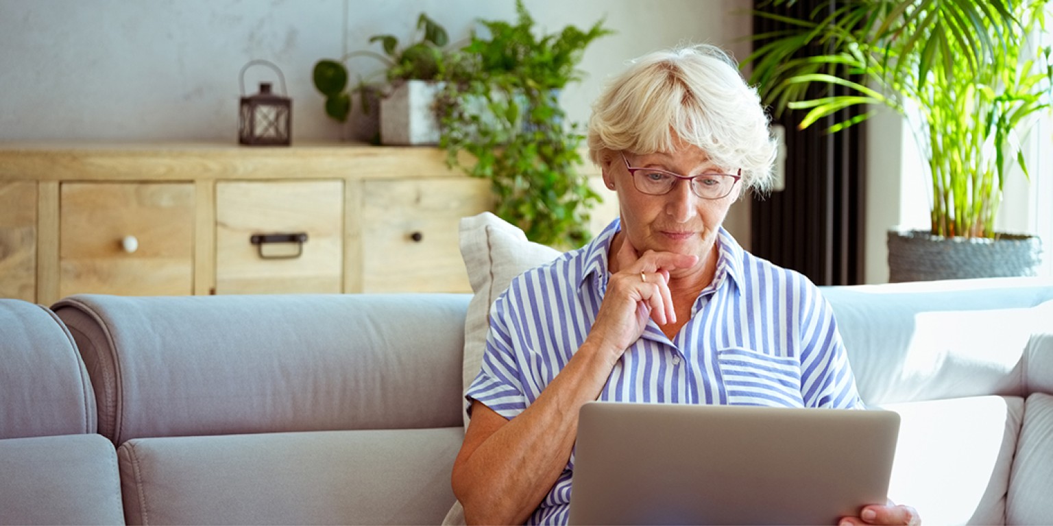 photo of a woman looking at a computer