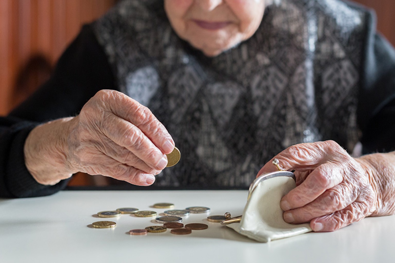 woman holding money in a coin purse