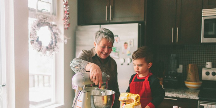 photo of grandmother and grandchild doing some baking in the kitchen