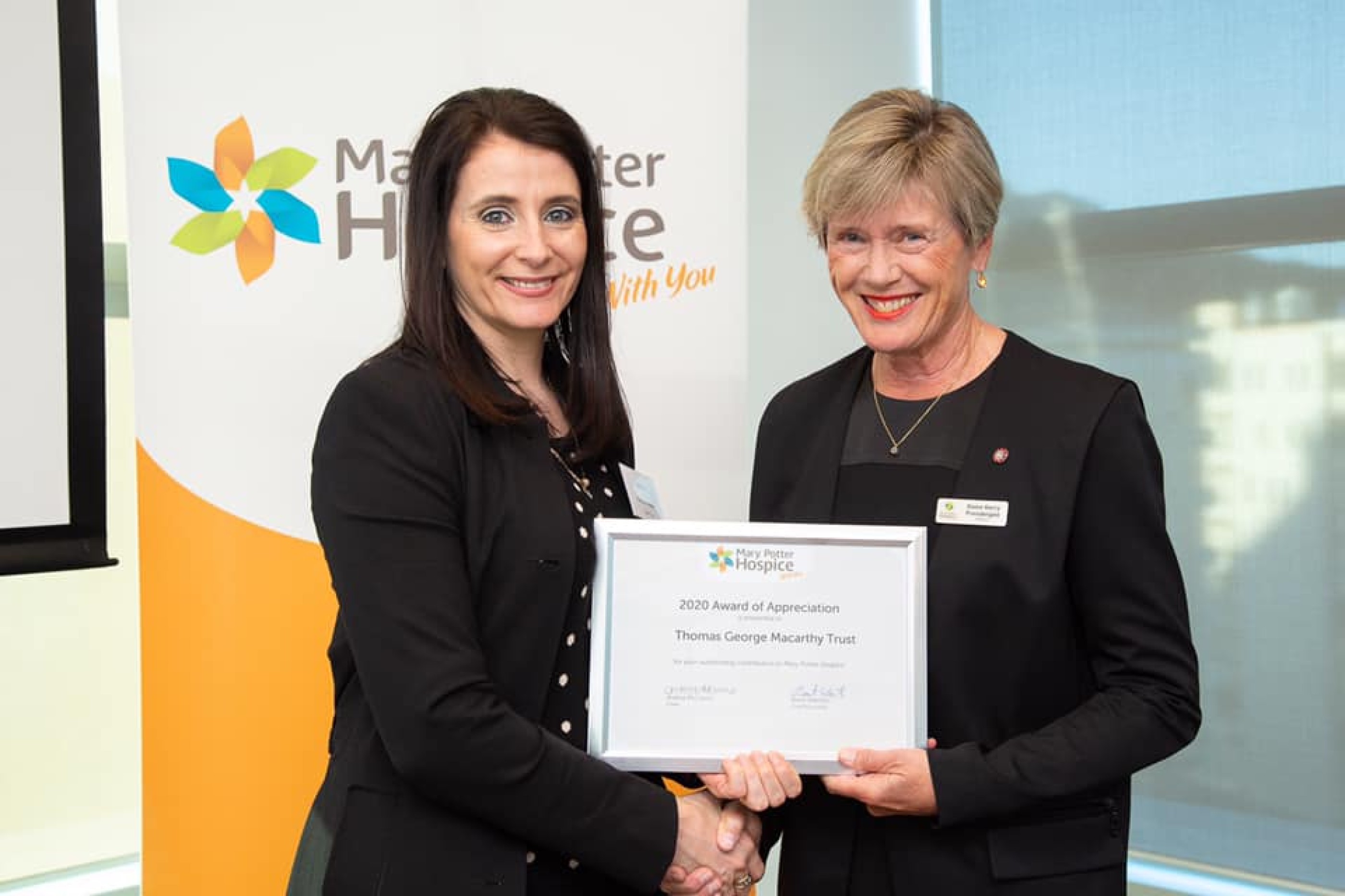 Natasha Naudé, Senior Client Advisor for Public Trust Charities receiving an award on behalf of the T G Macarthy Trust from Dame Kerry Prendergast, Patron of the Mary Potter Hospice, which has received over $3m from the Trust since 1980